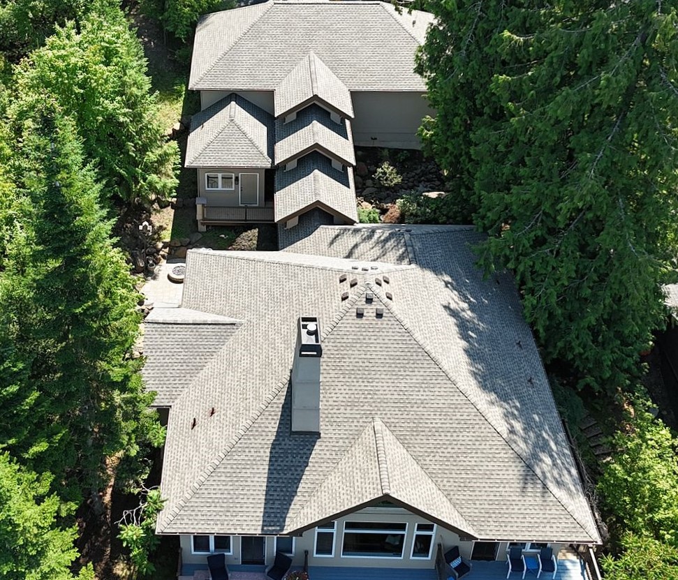 Drone shot of a Mid-class Home with Gray Slate Roof